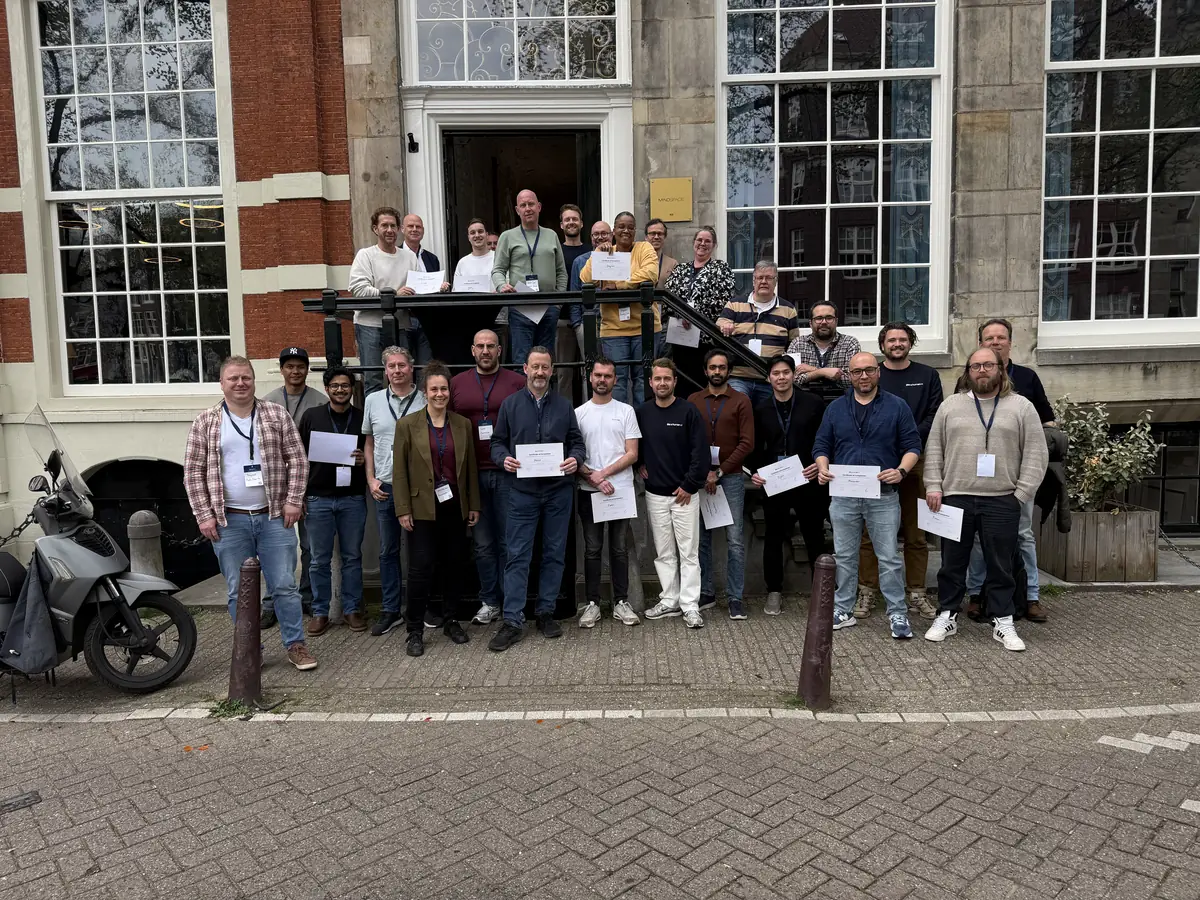 A group of participants outside the venue, each holding a certificate